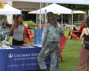 Student speaking to a rep from a university at the transfer fair