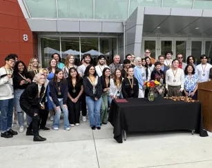 A group of graduating or transferring Saddleback College honors students pose for a group photo at the Honors Celebration event.