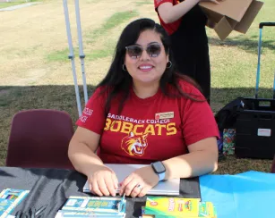 female saddleback college staff sitting at a table outdoors