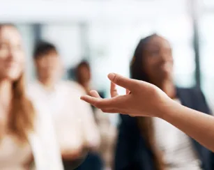 cropped shot of a businesswoman delivering a speech during a conference